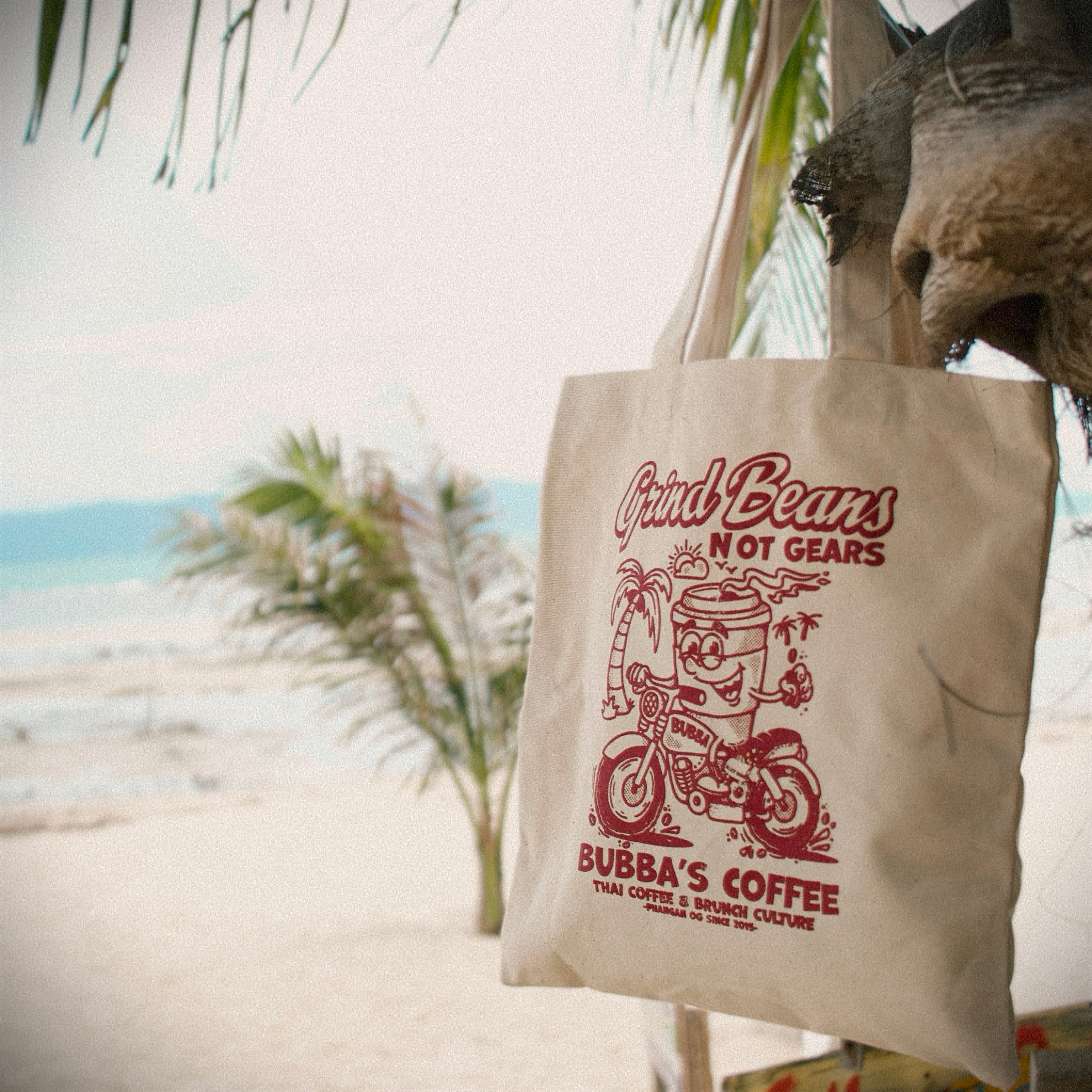 A Bubba's Coffee tote Bag hanging off a tree on the beach Koh Phangan